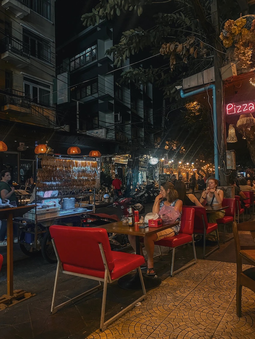 people sitting outside restaurants on soi rambuttri in bangkok