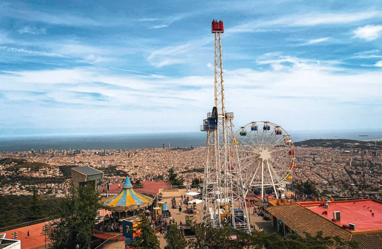 view from top of Mount Tibidabo with ferris wheel and amusements. Must see attractions on BARCELONA