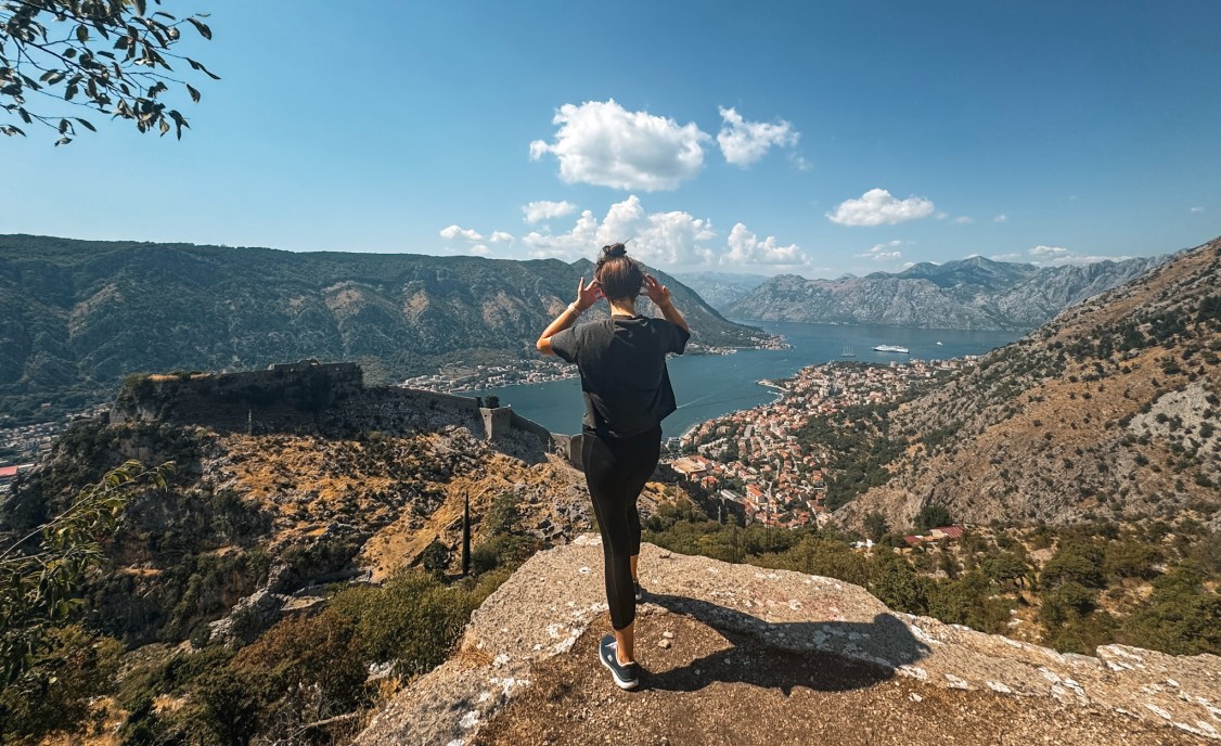 is kotor a nice place. woman standing looking over a bay