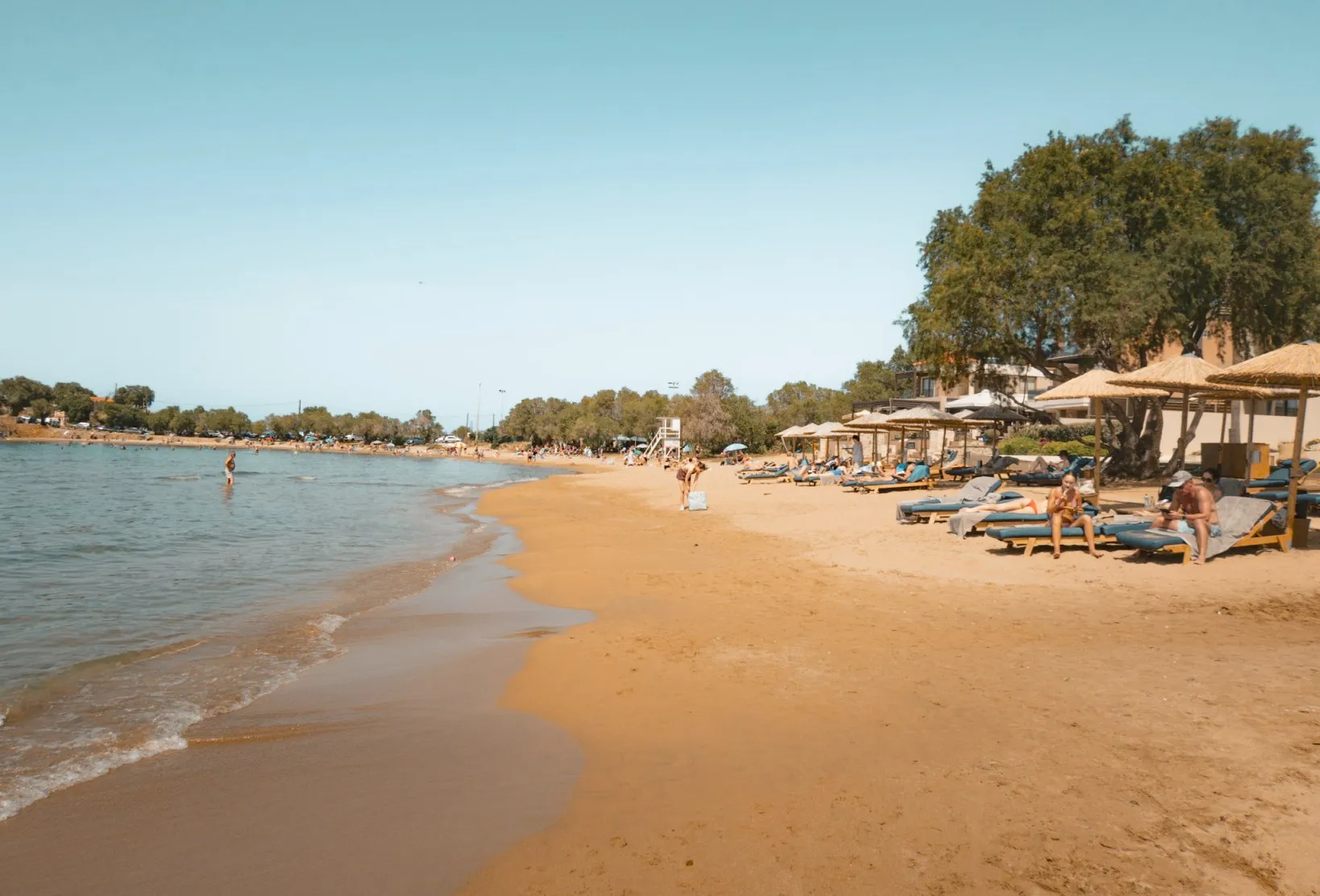 people lounging on sunbeds on Glaros Beach chania crete