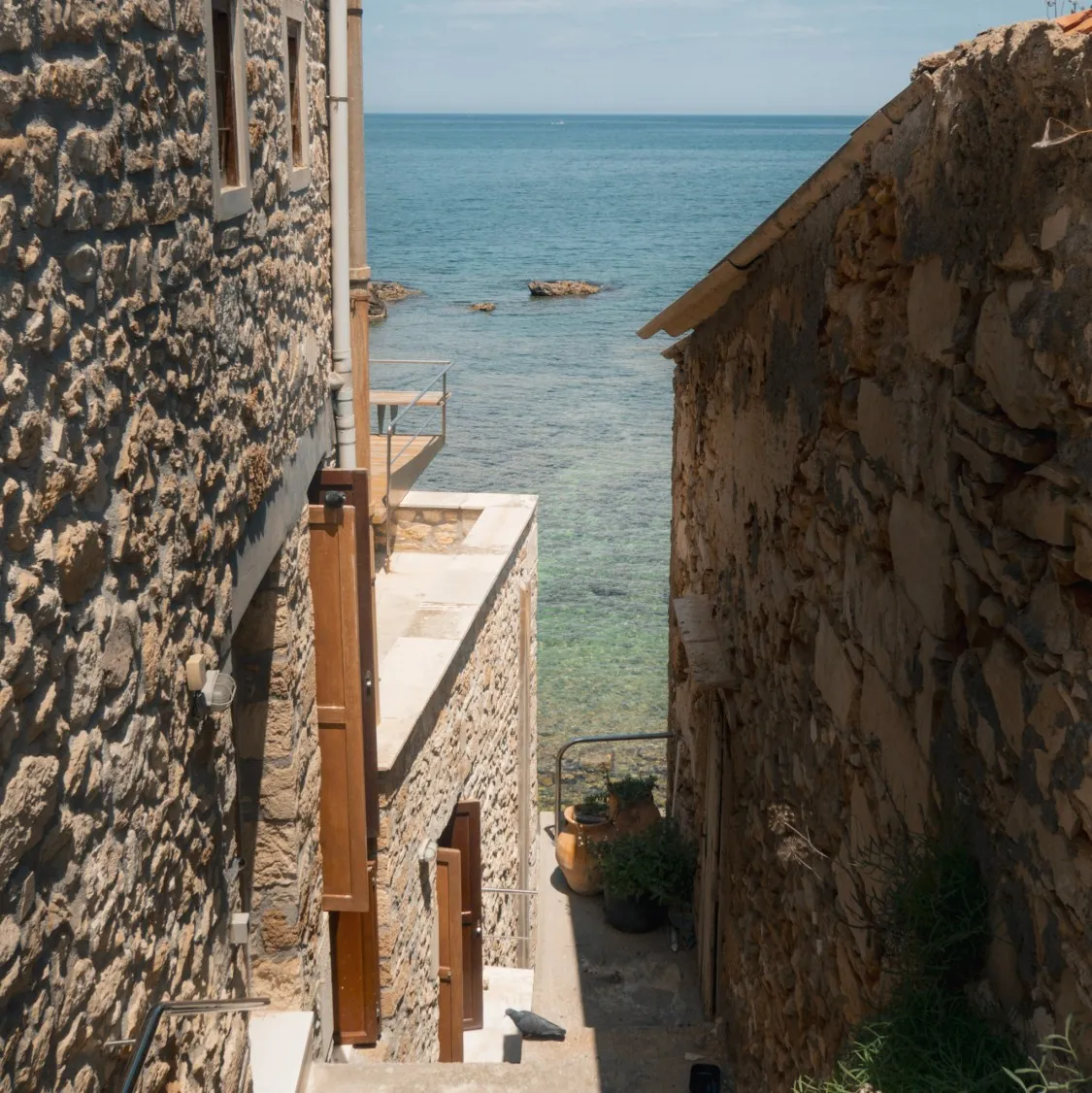 view of the ocean down a narrow alley in Tabakaria chania