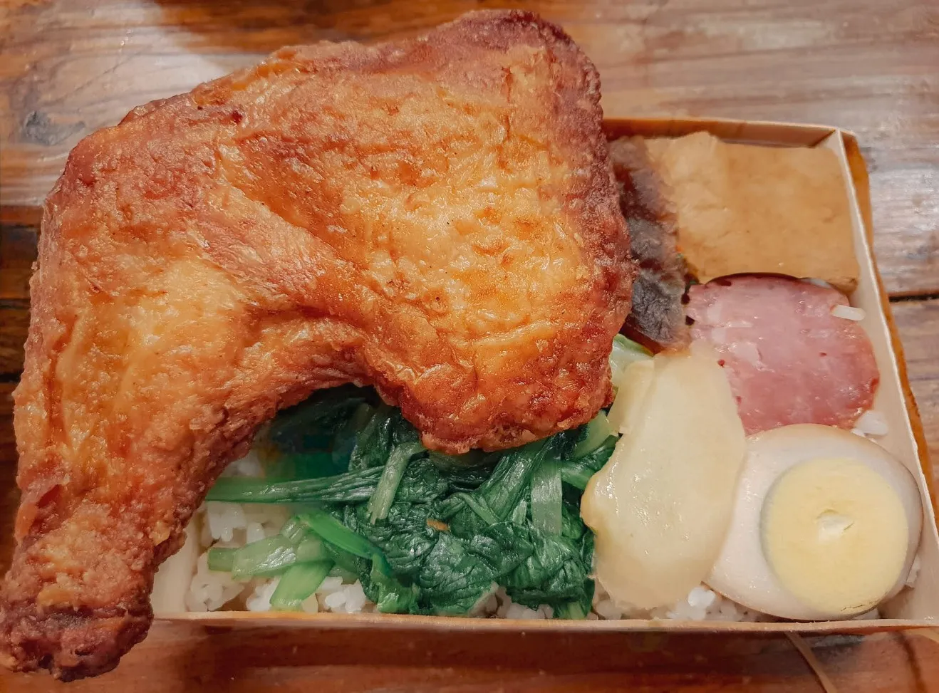 chishang bento box with fried chicken leg, vegetables and rice